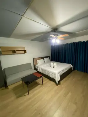 a bedroom with a bed and a couch in it at ไอริน ห้องพักรายวัน 2 in Thung Si Kan