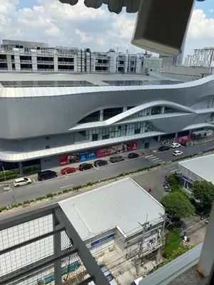 a large building with a parking lot in front of it at ไอริน ห้องพักรายวัน 2 in Thung Si Kan