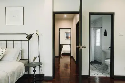 a bedroom with a bed and a bathroom at My Sukhumvit Villa in Bangkok