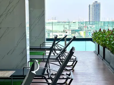 a row of chairs sitting on top of a balcony at monthly and Annual condo in Bangkok