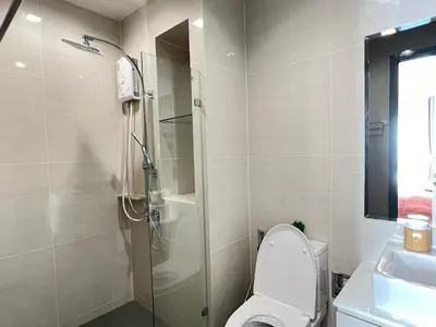a bathroom with a shower and a toilet and a sink at monthly and Annual condo in Bangkok