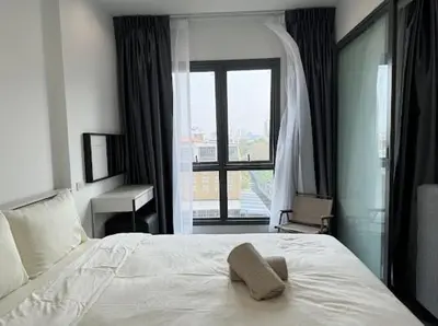 a bedroom with a white bed and a window at monthly and Annual condo in Bangkok