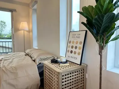 a room with a bed and a sign and a plant at hana villa in Bangkok
