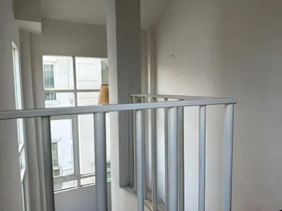 a metal railing in a room with a window at hana villa in Bangkok
