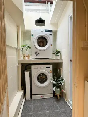 a washer and dryer in a small room at Nordic Townhouse FIT Group - 800M MRT Huaykwang in Bangkok