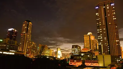 a city skyline at night with tall buildings at PanPan Hostel in Bangkok