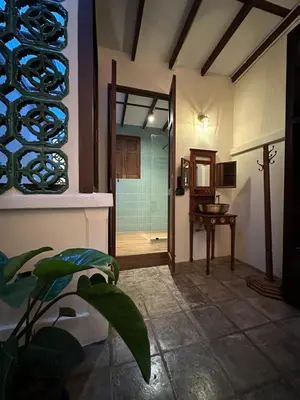 a bathroom with a glass door leading to a shower at The Courtesan at Yaowarat, townhome 80 Sqm in Samphanthawong