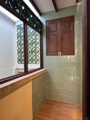 a bathroom with a window and green tiles at The Courtesan at Yaowarat, townhome 80 Sqm in Samphanthawong