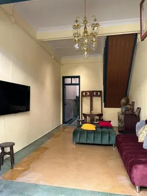 a living room with a couch and a flat screen tv at The Courtesan at Yaowarat, townhome 80 Sqm in Samphanthawong