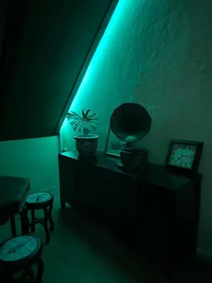 a dark room with a blue light and two stools at The Courtesan at Yaowarat, townhome 80 Sqm in Samphanthawong