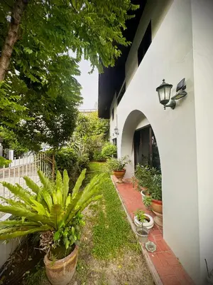 a courtyard with potted plants and a building at Newly-renovated Modern Private Thai Villa with Swimming Pool in Ban Khlong Samrong
