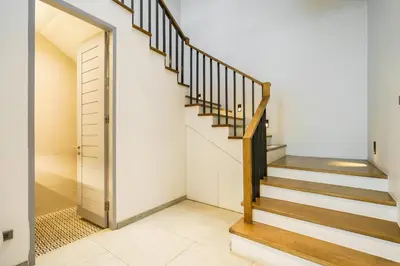 a staircase in a home with white walls at Designer Pool Villa in Ekkamai in Bangkok