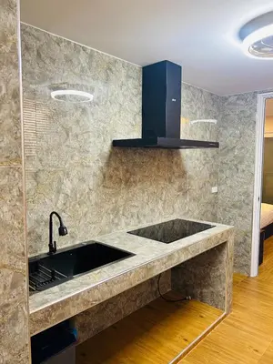 a kitchen with a sink and a counter top at Emiri Hotel - Nana Bangkok in Bangkok