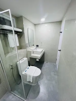 a bathroom with a toilet and a sink at Emiri Hotel - Nana Bangkok in Bangkok