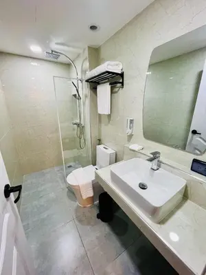 a bathroom with a sink and a toilet and a mirror at Emiri Hotel - Nana Bangkok in Bangkok