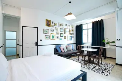 a bedroom with a bed and a table and a couch at xx The Character China Town MRT วัดมังกร in Bangkok