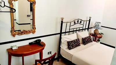 a bedroom with a bed and a mirror and a table at xx The Character China Town MRT วัดมังกร in Bangkok