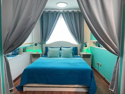 a bedroom with a blue bed and a large window at White Turquoise -2 Bedrooms Apartment- in Bangkok