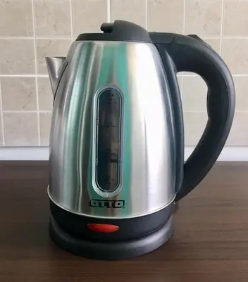 a tea kettle is sitting on a table at White Turquoise -2 Bedrooms Apartment- in Bangkok