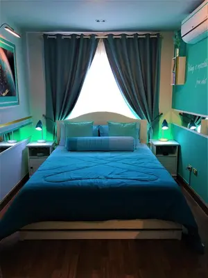 a bedroom with a blue bed and a large window at White Turquoise -2 Bedrooms Apartment- in Bangkok