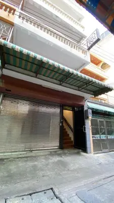 an outside view of a building with a gate and awning at z GO INN The Grand Palace Bangkok-Mrt Samyot Station in Bangkok
