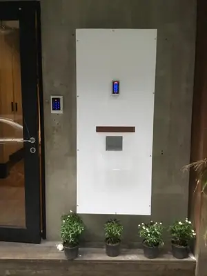 a white door with three potted plants in front of it at XX GO INN Silom Road -BTS Saint Louis in Bangkok