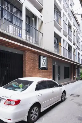 a white car parked in front of a building at XX GO INN Silom Road -BTS Saint Louis in Bangkok