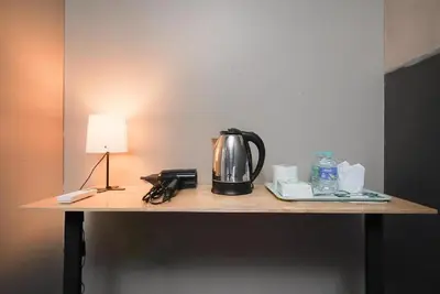 a table with a tea kettle and a lamp on it at XX GO INN Silom Road -BTS Saint Louis in Bangkok