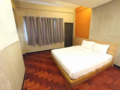 a white bed in a room with a window at XX GO INN Silom Road -BTS Saint Louis in Bangkok
