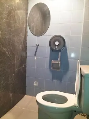 a bathroom with a toilet and a mirror at ONEWAY Guest House BKK in Bangkok