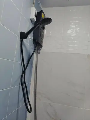 a blow dryer hanging on a wall in a bathroom at ONEWAY Guest House BKK in Bangkok