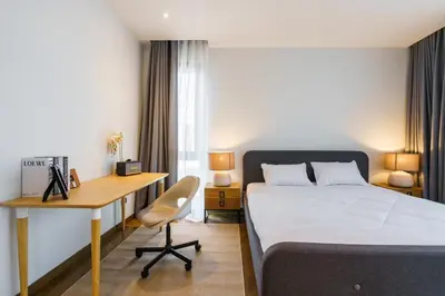 a bedroom with a bed and a desk and a bed at The Designer 49 Villa in Bangkok