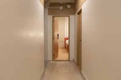 a hallway with a door leading to a room at Samyan Story Boutique Hotel in Bangkok