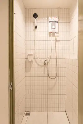 a bathroom with a shower with a phone on the wall at Samyan Story Boutique Hotel in Bangkok