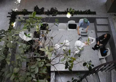 an overhead view of two people working in a garden at Cataleya Estate Boutique Bed & Breakfast in Bangkok