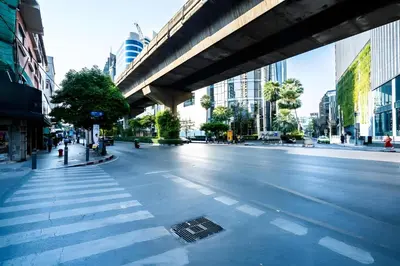 an empty street with an overpass in a city at Elite Hotel Asok Sukhumvit 20 in Bangkok