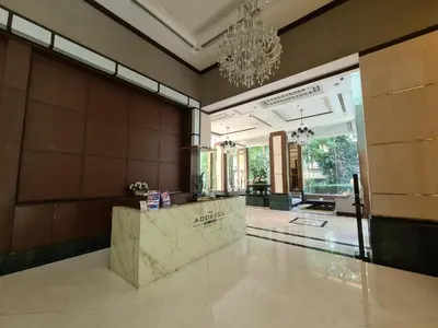 a lobby with a reception desk and a chandelier at The Address Chidlom 41sqm Studio 650m BTS Chit Lom in Bangkok