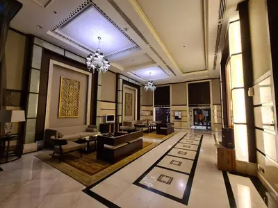 a living room with a chandelier and a lobby at The Address Chidlom 41sqm Studio 650m BTS Chit Lom in Bangkok
