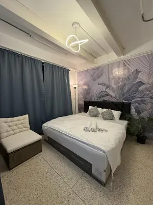 a bedroom with a large bed and a chair at Twenty Two Place Sukhumvit 22 in Bangkok