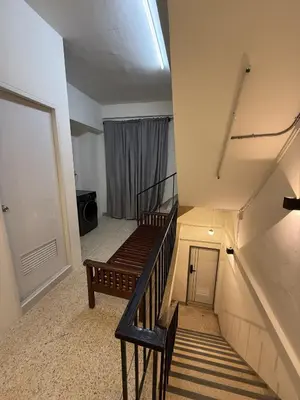a stairway with a wooden bench in a room at Twenty Two Place Sukhumvit 22 in Bangkok