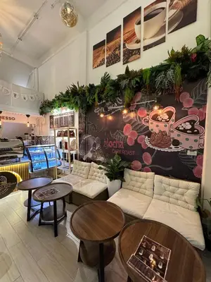 a room with tables and couches in a store at Twenty Two Place Sukhumvit 22 in Bangkok