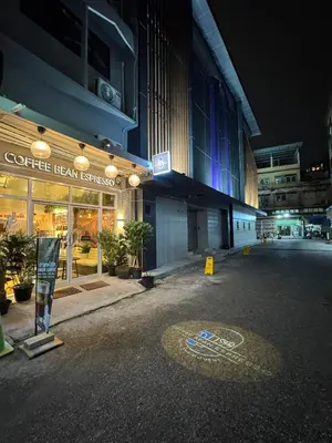 an empty street in front of a building at night at Twenty Two Place Sukhumvit 22 in Bangkok