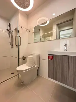 a bathroom with a toilet and a sink and a mirror at 1BHK Apt High floor in Thonglor WiFi-Pool-Fitness in Bangkok