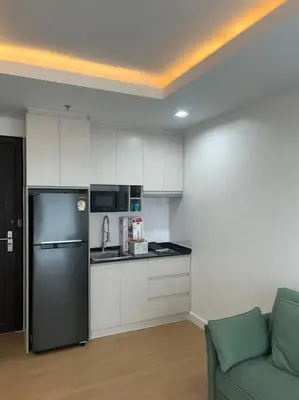 a kitchen with a refrigerator and a couch in a room at 1BHK Apt High floor in Thonglor WiFi-Pool-Fitness in Bangkok