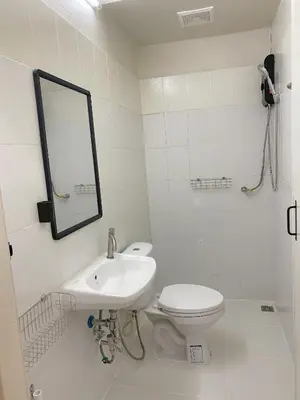 a bathroom with a toilet and a sink and a mirror at Cozy Corner Bangpho in Bang Su