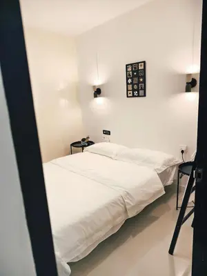 two beds in a white room with two tables at Fivehouse Silom1 - City heart - Silom -BTS MRT 2min - lumpini park - bnh in Bangkok