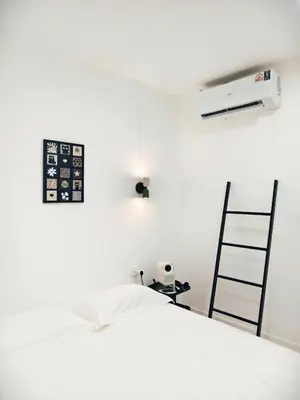 a white bedroom with a bed and a desk and a fan at Fivehouse Silom1 - City heart - Silom -BTS MRT 2min - lumpini park - bnh in Bangkok