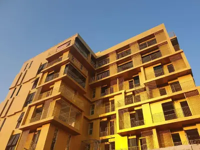 a tall building with balconies on the side of it at Breezewood Bangkok Hotel in Bang Su
