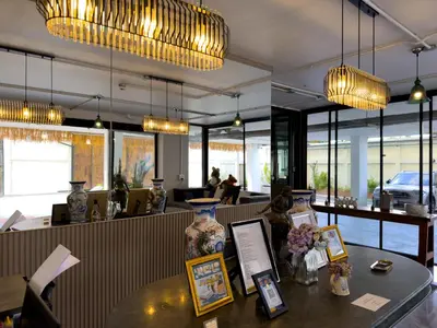 a restaurant with a table with a vase on it at Breezewood Bangkok Hotel in Bang Su