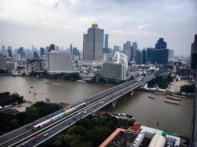 a bridge over a river with a city at Riverside room with best view in heart of BKK in Godown